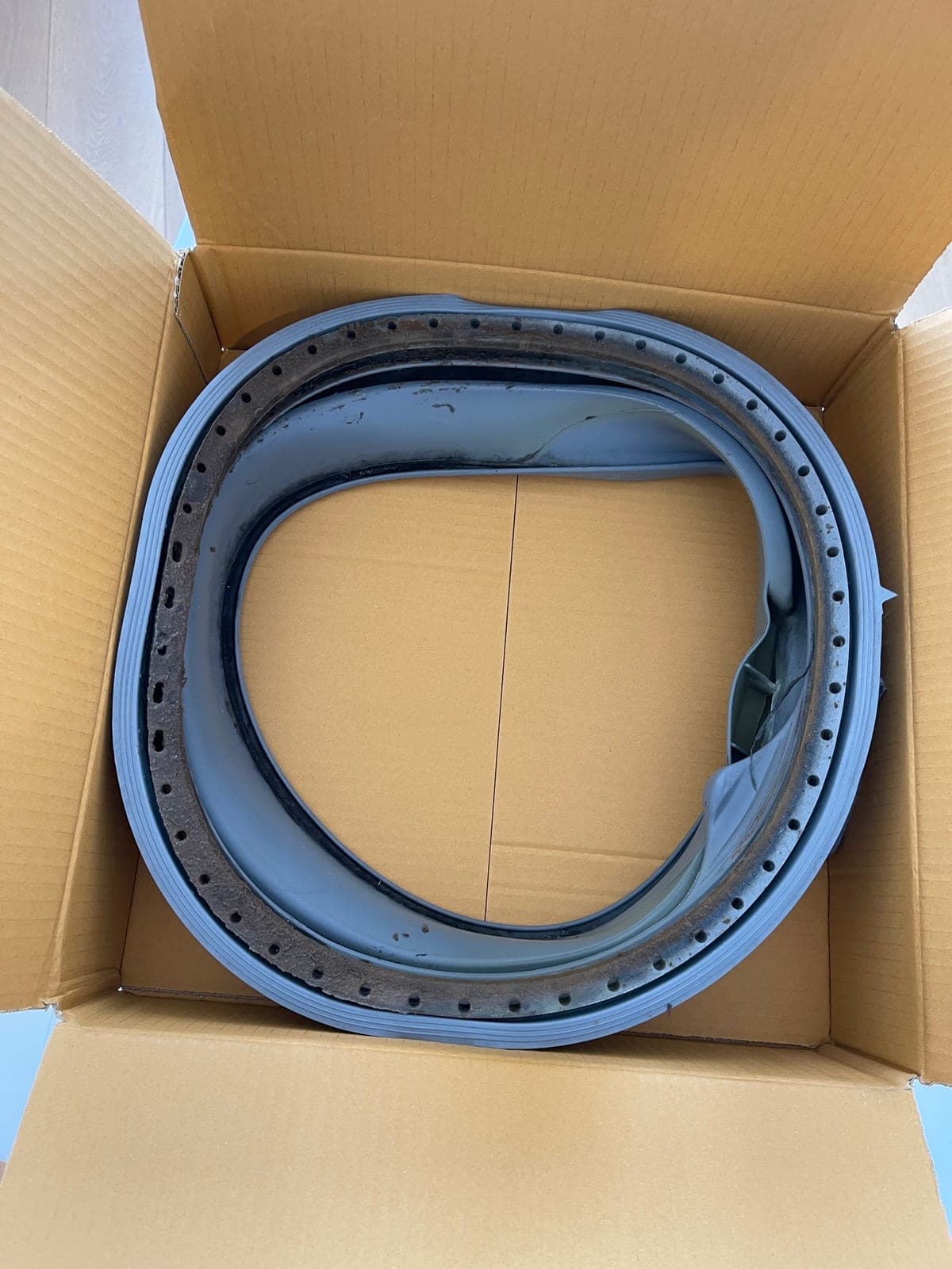 A replacement washing machine door seal ready to be fitted.